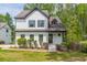 Stunning two-story home with a white exterior, dark trim, and a well-manicured front yard at 1410 Eastland Rd Se Rd, Atlanta, GA 30316