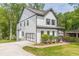 Back of home with large garage doors and balcony overlooking the well maintained grounds and mature trees at 1410 Eastland Rd Se Rd, Atlanta, GA 30316