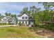Charming white house with dark trim, well-maintained lawn, and mature trees, offering a welcoming appeal at 1410 Eastland Rd Se Rd, Atlanta, GA 30316
