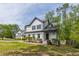 Inviting two-story house featuring a white exterior, dark shutters, and professionally landscaped front yard at 1410 Eastland Rd Se Rd, Atlanta, GA 30316