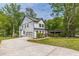 Spacious home showcasing a long driveway leading to a garage, complemented by a lush green lawn at 1410 Eastland Rd Se Rd, Atlanta, GA 30316