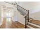 View of the foyer showcasing hardwood flooring, stairway with iron balusters, and coffered ceiling at 1410 Eastland Rd Se Rd, Atlanta, GA 30316