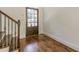 Elegant foyer with hardwood floors, a decorative front door, and stairway with wrought iron spindles at 1410 Eastland Rd Se Rd, Atlanta, GA 30316
