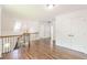 This hallway features hardwood floors, a staircase, and white painted walls at 1410 Eastland Rd Se Rd, Atlanta, GA 30316