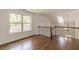 This hallway boasts gleaming hardwood floors and an elegant wrought iron railing at 1410 Eastland Rd Se Rd, Atlanta, GA 30316