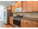 Kitchen with granite countertops, stainless steel appliances, wood cabinets, and center island at 1410 Eastland Rd Se Rd, Atlanta, GA 30316
