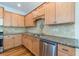 Kitchen featuring wooden cabinets, granite countertops, stainless steel appliances, and tile backsplash at 1410 Eastland Rd Se Rd, Atlanta, GA 30316