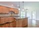 Kitchen featuring wood cabinets, granite countertops, tile backsplash, and a kitchen island at 1410 Eastland Rd Se Rd, Atlanta, GA 30316