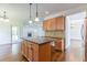 Kitchen with granite island, pendant lights, wooden cabinets, and stainless steel appliances at 1410 Eastland Rd Se Rd, Atlanta, GA 30316