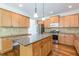 Bright kitchen with granite countertops, wood cabinets, stainless steel appliances, and kitchen island at 1410 Eastland Rd Se Rd, Atlanta, GA 30316