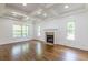 Bright living room with hardwood floors, coffered ceilings, recessed lighting, a fireplace and large windows for ample sunlight at 1410 Eastland Rd Se Rd, Atlanta, GA 30316