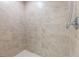 Elegant shower is detailed with textured wall tiles and white floor tiling, and features a mounted shower head at 1410 Eastland Rd Se Rd, Atlanta, GA 30316