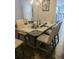 Dining room featuring chandelier lighting, and seating for six at a glass topped table with wood base at 3272 Baylor Cir, Mcdonough, GA 30253