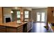 Open kitchen view into living area with granite counters and stainless sink at 3272 Baylor Cir, Mcdonough, GA 30253