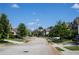 Serene street view of suburban homes with mature trees, manicured lawns, and wide sidewalks at 3272 Baylor Cir, Mcdonough, GA 30253