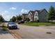 Desirable suburban street view of charming homes with mature trees, manicured lawns, and a sidewalk at 3272 Baylor Cir, Mcdonough, GA 30253