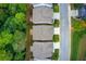 Aerial perspective showing home rooftops nestled amidst lush trees, along with backyard patios and manicured landscaping for serene outdoor living at 550 Constellation Overlook Sw, Atlanta, GA 30331