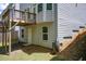 Back of home with a small deck and an unfinished area, with a rain barrel and exterior access at 550 Constellation Overlook Sw, Atlanta, GA 30331