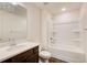 Well-lit bathroom featuring a shower-tub combo and a dark vanity with a light countertop at 550 Constellation Overlook Sw, Atlanta, GA 30331