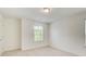 Bright bedroom with neutral carpet and a window that offers a lush green view at 550 Constellation Overlook Sw, Atlanta, GA 30331