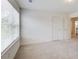 Carpeted bedroom with two doors and a large window allowing natural light at 550 Constellation Overlook Sw, Atlanta, GA 30331
