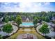 Aerial perspective highlights community pool, clubhouse, playground amenities amidst a serene neighborhood setting, inviting recreational opportunities at 550 Constellation Overlook Sw, Atlanta, GA 30331