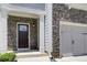 Close up of a front door and stone-accented exterior, offering great curb appeal at 550 Constellation Overlook Sw, Atlanta, GA 30331