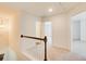 Upstairs hallway with neutral carpet leading to several bedrooms at 550 Constellation Overlook Sw, Atlanta, GA 30331