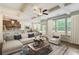 Comfortable living room features a coffered ceiling, ceiling fan, hardwood flooring, and lots of natural light at 550 Constellation Overlook Sw, Atlanta, GA 30331