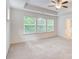 Primary bedroom with neutral carpet, three windows, and ceiling fan at 550 Constellation Overlook Sw, Atlanta, GA 30331