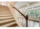 Staircase with hardwood treads and white risers located next to the living room at 550 Constellation Overlook Sw, Atlanta, GA 30331