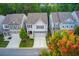 Charming two-story homes with stone accents, manicured lawns and driveways surrounded by mature trees in a neighborhood setting at 550 Constellation Overlook Sw, Atlanta, GA 30331