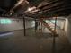 Unfinished basement space with exposed ceiling beams, ductwork, support pillars, and concrete floor at 6106 Oak Hill Sw Dr, Austell, GA 30168