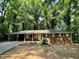Charming brick home with a covered carport and lush green surroundings at 6106 Oak Hill Sw Dr, Austell, GA 30168