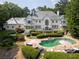 Beautiful backyard with a pool, hot tub, patio, lounge furniture, and lush landscaping at 70 Finch Forest Trl, Atlanta, GA 30327