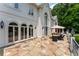 The home's back patio features an outdoor dining set, flagstone floor, manicured landscaping, and outdoor lighting at 70 Finch Forest Trl, Atlanta, GA 30327