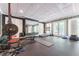Basement home gym features a weight rack, treadmill, mirror and rubber flooring at 70 Finch Forest Trl, Atlanta, GA 30327