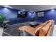 Basement living room with a leather couch and a large tv at 70 Finch Forest Trl, Atlanta, GA 30327