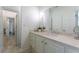 Bathroom with marble countertop, cabinets, vanity, and a view down the hallway at 70 Finch Forest Trl, Atlanta, GA 30327