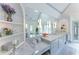 Bathroom with marble countertop, vanity, and a large mirror reflecting the soaking tub and natural light at 70 Finch Forest Trl, Atlanta, GA 30327