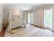 Cozy bedroom with a four-poster bed, draped curtains, area rug, and natural light at 70 Finch Forest Trl, Atlanta, GA 30327