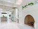 Bright kitchen featuring stainless appliances, bar seating, a fireplace, and tile floors at 70 Finch Forest Trl, Atlanta, GA 30327