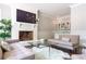 Inviting living room with a cozy fireplace, wet bar, and comfortable sofas at 70 Finch Forest Trl, Atlanta, GA 30327