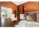 Cozy living room featuring wood paneling, fireplace, and comfortable chairs at 70 Finch Forest Trl, Atlanta, GA 30327