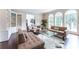 Bright living room featuring built-in shelving, arched windows, and plush seating at 70 Finch Forest Trl, Atlanta, GA 30327