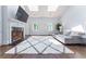 Living room features a fireplace, a TV mounted above, large windows, and a cozy couch at 70 Finch Forest Trl, Atlanta, GA 30327