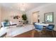 Stylish sitting room featuring eclectic decor, chandeliers, and designer furniture at 70 Finch Forest Trl, Atlanta, GA 30327