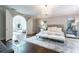 This main bedroom features hardwood floors, a chandelier, an archway, and a luxurious rug at 70 Finch Forest Trl, Atlanta, GA 30327