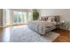 Bedroom features hardwood floors, large windows with shutters, and stylish decor at 70 Finch Forest Trl, Atlanta, GA 30327