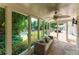 Spacious sunroom with outdoor furniture, flagstone floor, and a tranquil view of the pool and backyard at 70 Finch Forest Trl, Atlanta, GA 30327